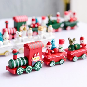 Festive wooden Christmas train ornament with red and green carriages on white background