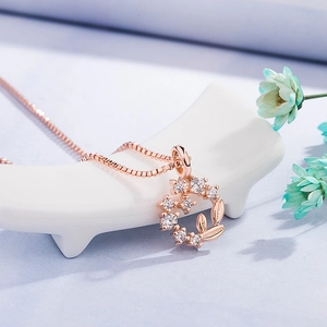 Rose gold daisy wreath necklace with white crystals on box chain for women