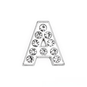 Macro shot of silver metal letter A charm with white zircon crystals for DIY bracelets