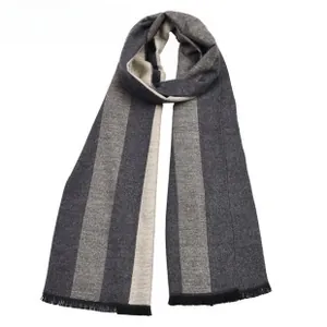 Detail of grey striped knit scarf texture featuring fine black fringe tassels on edges