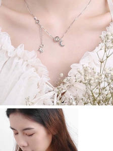 Detail of silver unicorn and moon pendant necklace with crystals on a female model