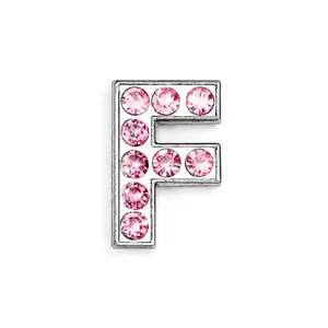 Detailed view of silver letter F charm with sparkling pink rhinestones for DIY jewelry