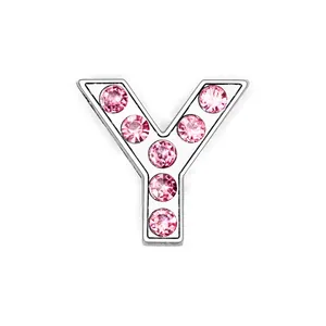 Macro shot of silver Y-letter pendant with six sparkling pink zircons for DIY jewelry