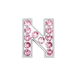 Detail view of pink rhinestone-encrusted silver metal letter N pendant charm