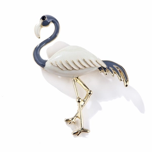 Elegant flamingo brooch with white enamel and blue feathers on a golden alloy base