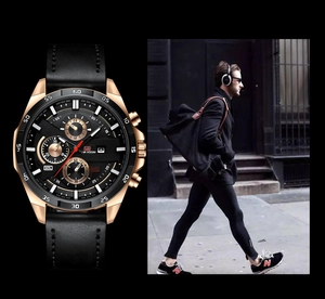 Detail of rose gold men's chronograph watch with black leather strap and date window