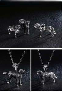 Macro detail of silver stainless steel poodle dog pendant with textured fur carving