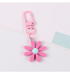 Close-up of pink daisy flower keychain with matching pink metal spring clip and ring