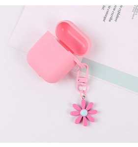 Detailed view of a pink daisy flower charm attached to a silicone AirPods protective case