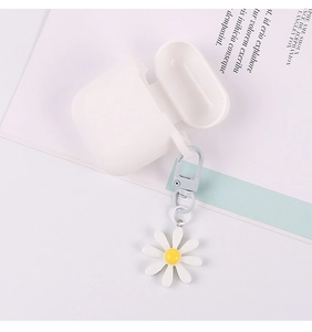 Detail of white silicone AirPods case with cute daisy floral pendant and metal clip