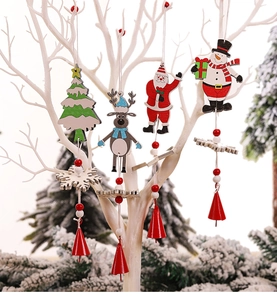 Close-up of painted wooden Christmas ornaments including Santa and reindeer on white branches