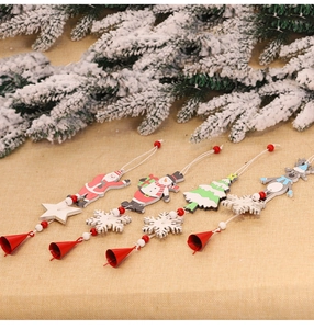 Detailed view of four wooden Christmas pendants with Santa, snowman, deer and festive bells