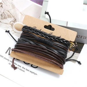 Handmade multi-layer braided leather bracelet set with retro style cards on a lifestyle background