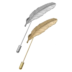 Men's feather lapel pins set in gold and silver tones with metallic leaf textures