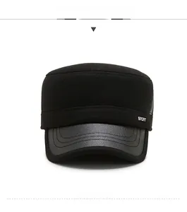 Detail of men's winter flat cap featuring a textured fabric and stitched leather brim