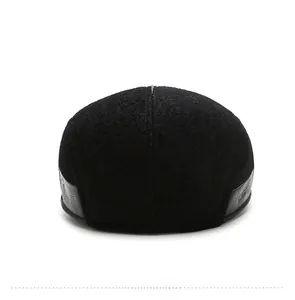 Rear view of men's black wool newsboy cap featuring detailed leather trim on the back