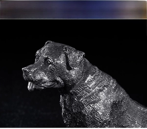 Detailed close-up of a vintage stainless steel dog head sculpture with realistic fur texture