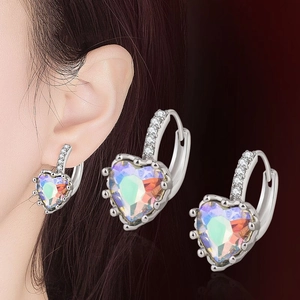 Detail of heart-shaped silver earrings featuring opal stones and diamond accents