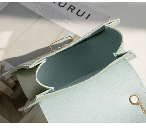 Close-up of mint green leather crossbody bag showing inner suede lining and flap design