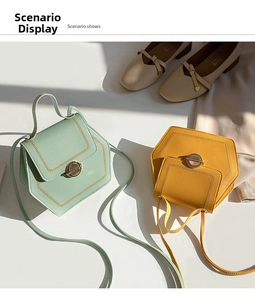 Detail view of mint green and mustard yellow hexagon crossbody bags with gold hardware