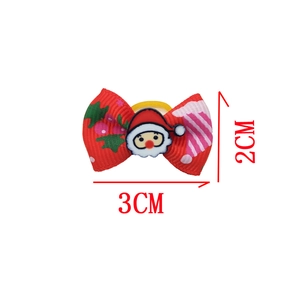 Detailed view of 3x2cm Christmas pet hair bow with Santa Claus and holly patterns