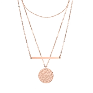 Layered rose gold necklace featuring a minimalist bar and hammered disc pendant detail