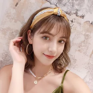 Elegant yellow satin knotted headband with sparkling rhinestones for women's hair styling