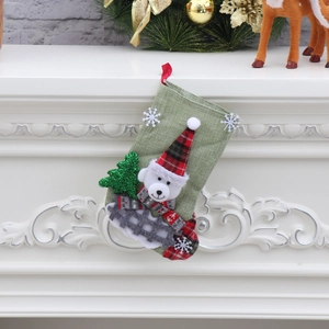 Close-up of a green linen Christmas stocking with a 3D bear hanging on a white fireplace