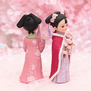 Detailed view of Chinese palace-style girls resin dolls with floral patterns and tassels