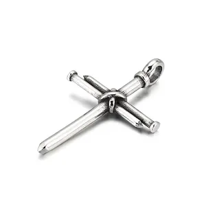 Industrial punk style cross pendant made of three stainless steel nails with vintage finish