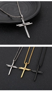 Detailed view of punk cross pendants in silver, gold, and black with nail-inspired design