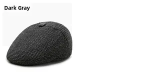 Detailed view of dark grey knitted newsboy cap with wool blend texture and top button decoration