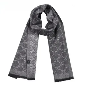 Detailed close-up of dark grey jacquard scarf showing geometric patterns and fringe edges