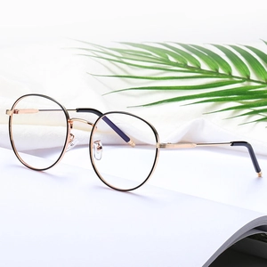 Retro round metal glasses frame in black and rose gold on a minimalist white background