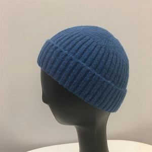 Blue mohair knit skullcap beanie with vertical ribbing texture on a display mannequin