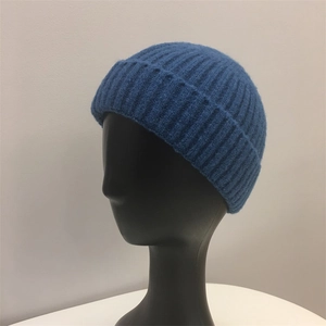 Close-up of blue ribbed knit beanie featuring thick wool texture and folded cuff detail