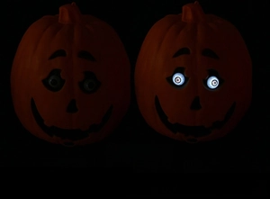 Comparison of Halloween pumpkin lantern in unlit and glowing states with white LED eyes