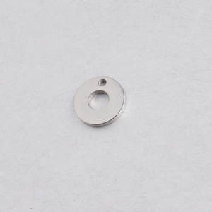 Macro shot of mirror-polished silver stainless steel round pendant with dual-hole design