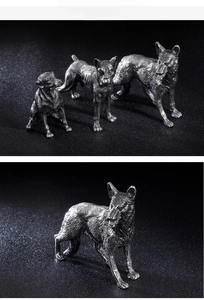 Macro detail of antique silver dog figurine showing realistic muscular lines and metallic texture