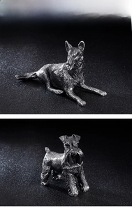 Macro detail of retro silver stainless steel dog figurines showing realistic fur textures