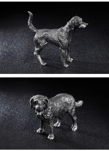 Detailed view of silver stainless steel dog figurines with polished metallic finish