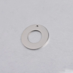 Close-up of polished silver stainless steel hollow circular pendant with top hanging hole