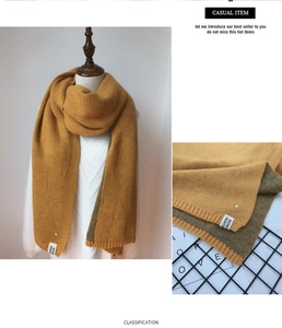 Détail de l'écharpe en maille jaune avec broderie ananas et étiquette en tissu pour femme
