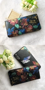 Detail of floral butterfly embossed pattern on black leather long zipper wallet