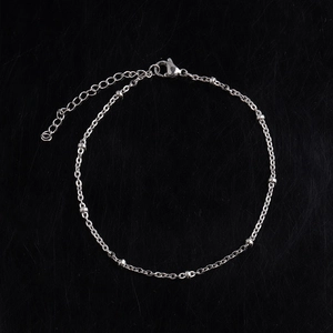 Detailed view of silver stainless steel anklet with small beads and lobster clasp closure