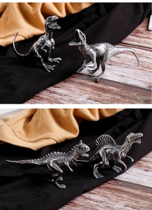 Detailed set of four metallic dinosaur figurines in dark silver for creative home decor
