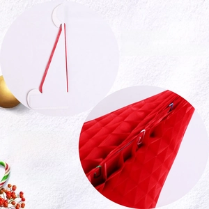Detail view of red honeycomb paper Christmas decoration with clip assembly steps