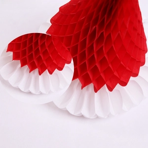 Close-up of red and white honeycomb paper Christmas decoration with detailed folding texture