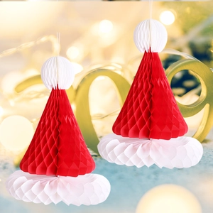 Close-up of two red and white honeycomb paper Christmas hat hanging ornaments for party décor