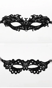Detail showing two styles of black lace eye masks with intricate embroidery and silk ribbons
